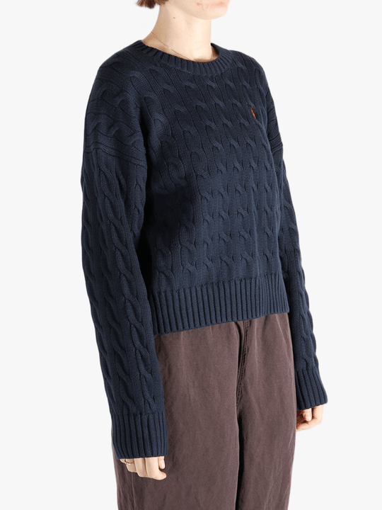 Black sweater worn by a person, showing the sweater fit