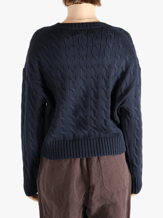 Black sweater worn by a person, showing the sweater fit