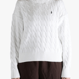 White sweater worn by a person, showing the sweater fit