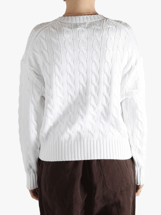 White sweater worn by a person, showing the sweater fit