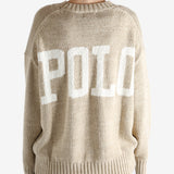 A tan sweater worn by a person, showing the sweater's fit
