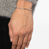 Silver bracelet worn by a person, showing the bracelet fit