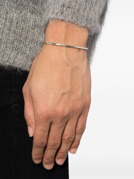 Silver bracelet worn by a person, showing the bracelet fit
