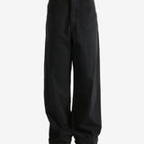 Black trousers worn by a person, showing the trousers fit