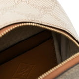 Close up of tan backpack, showing texture of the canvas and leather fabric