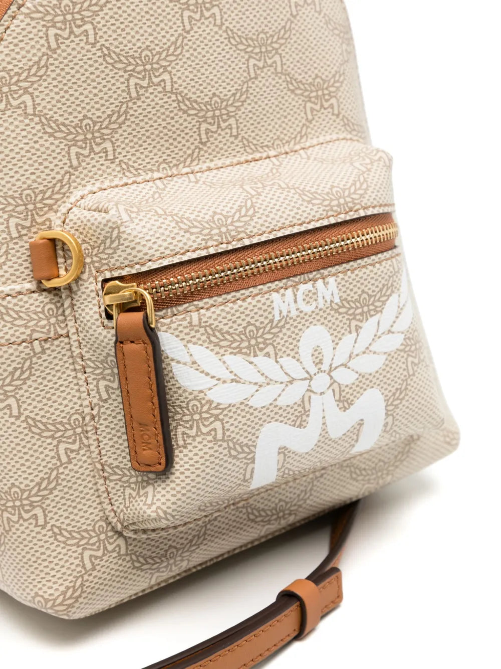 Close up of tan backpack, showing texture of the canvas and leather fabric