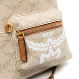 Close up of tan backpack, showing texture of the canvas and leather fabric