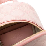Close up of pink backpack, showing texture of the canvas fabric