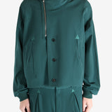 Green jacket worn by a person, showing the jacket's fit