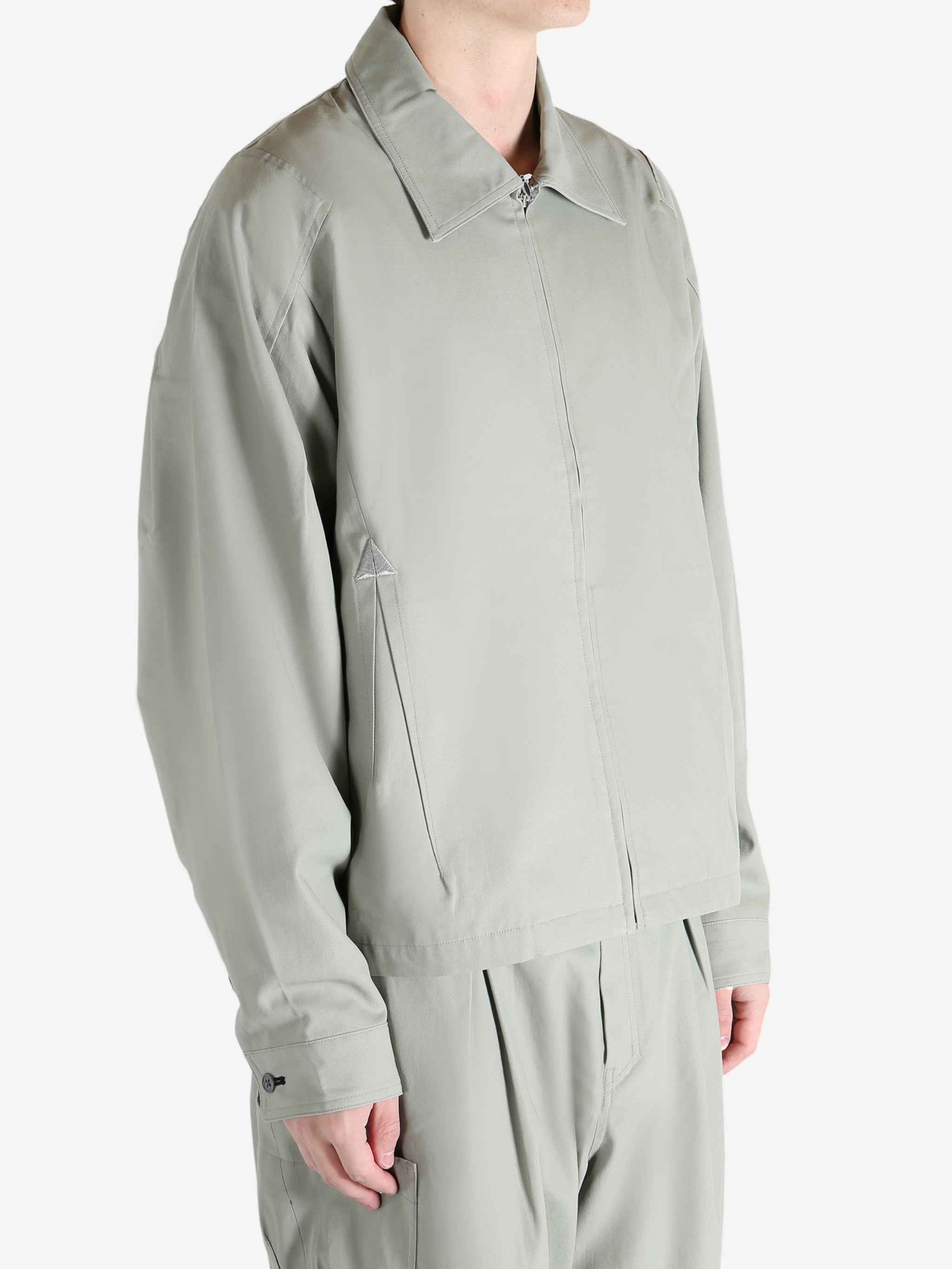 Grey jacket worn by a person, showing the jacket's fit