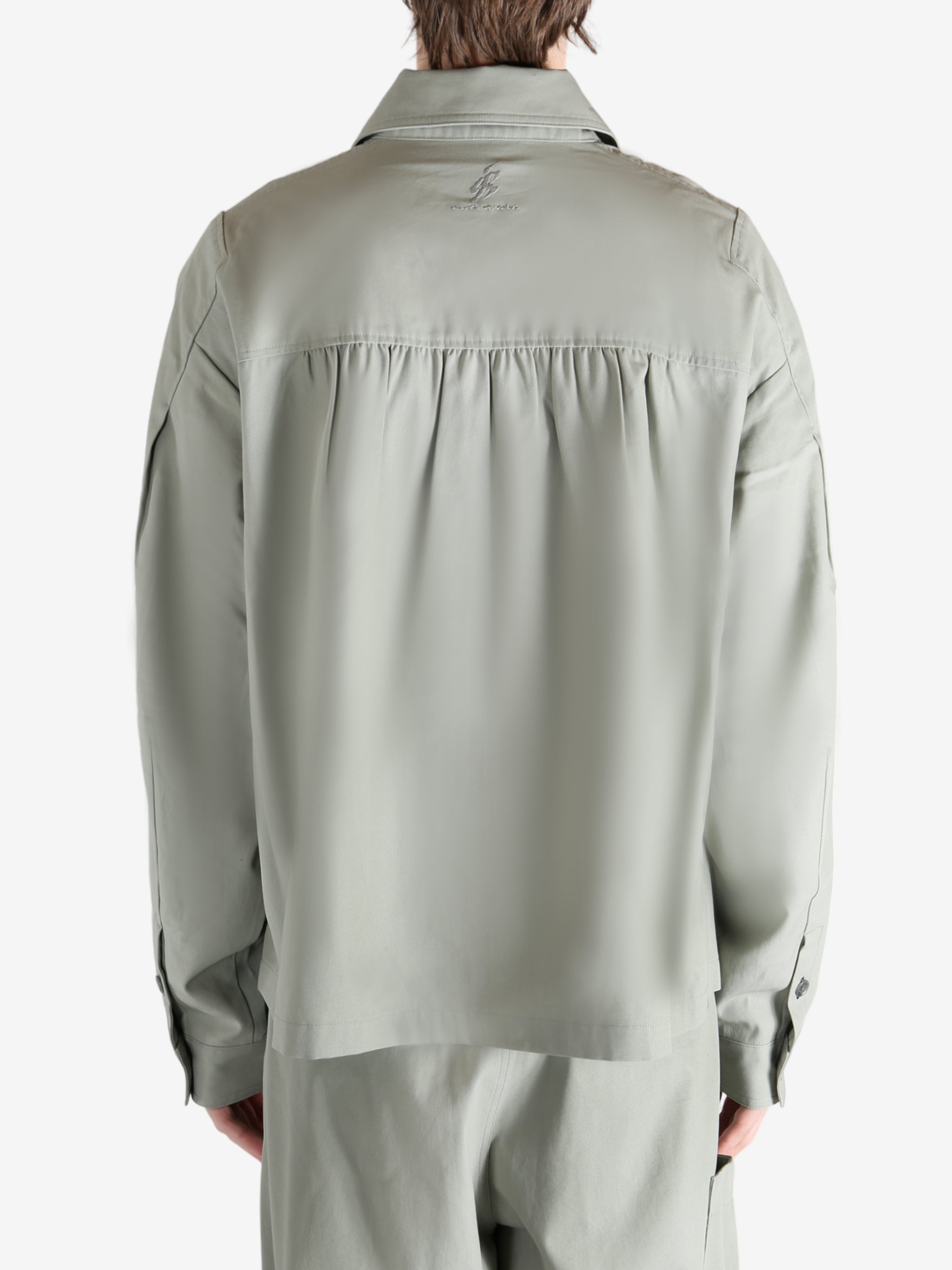 Grey jacket worn by a person, showing the jacket's fit