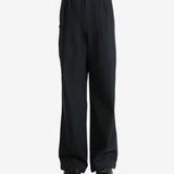 Black pants worn by a person, showing the pants' fit