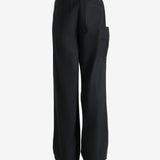 Black pants worn by a person, showing the pants' fit