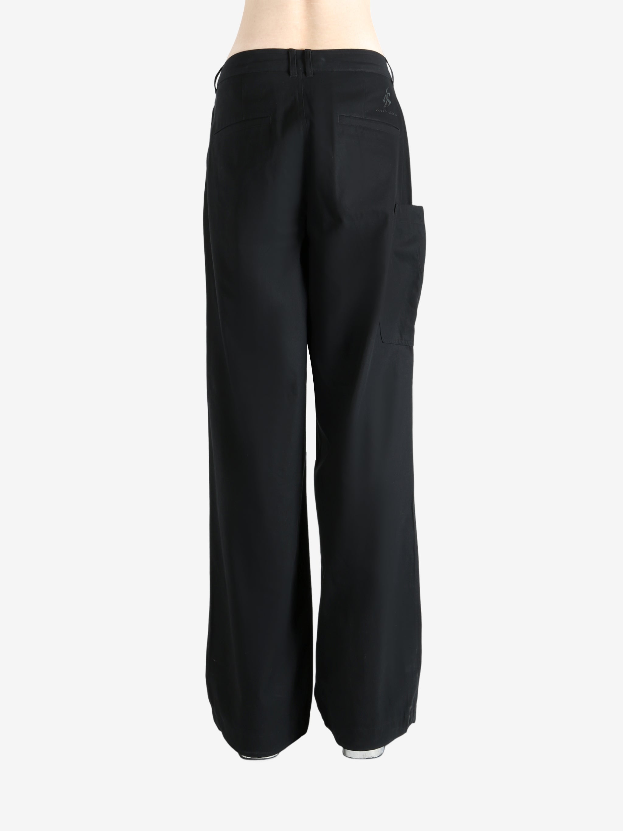 Black pants worn by a person, showing the pants' fit