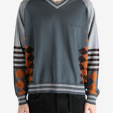 Grey jumper worn by a person, showing the jumper's fit