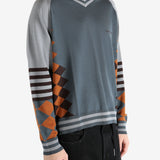 Grey jumper worn by a person, showing the jumper's fit