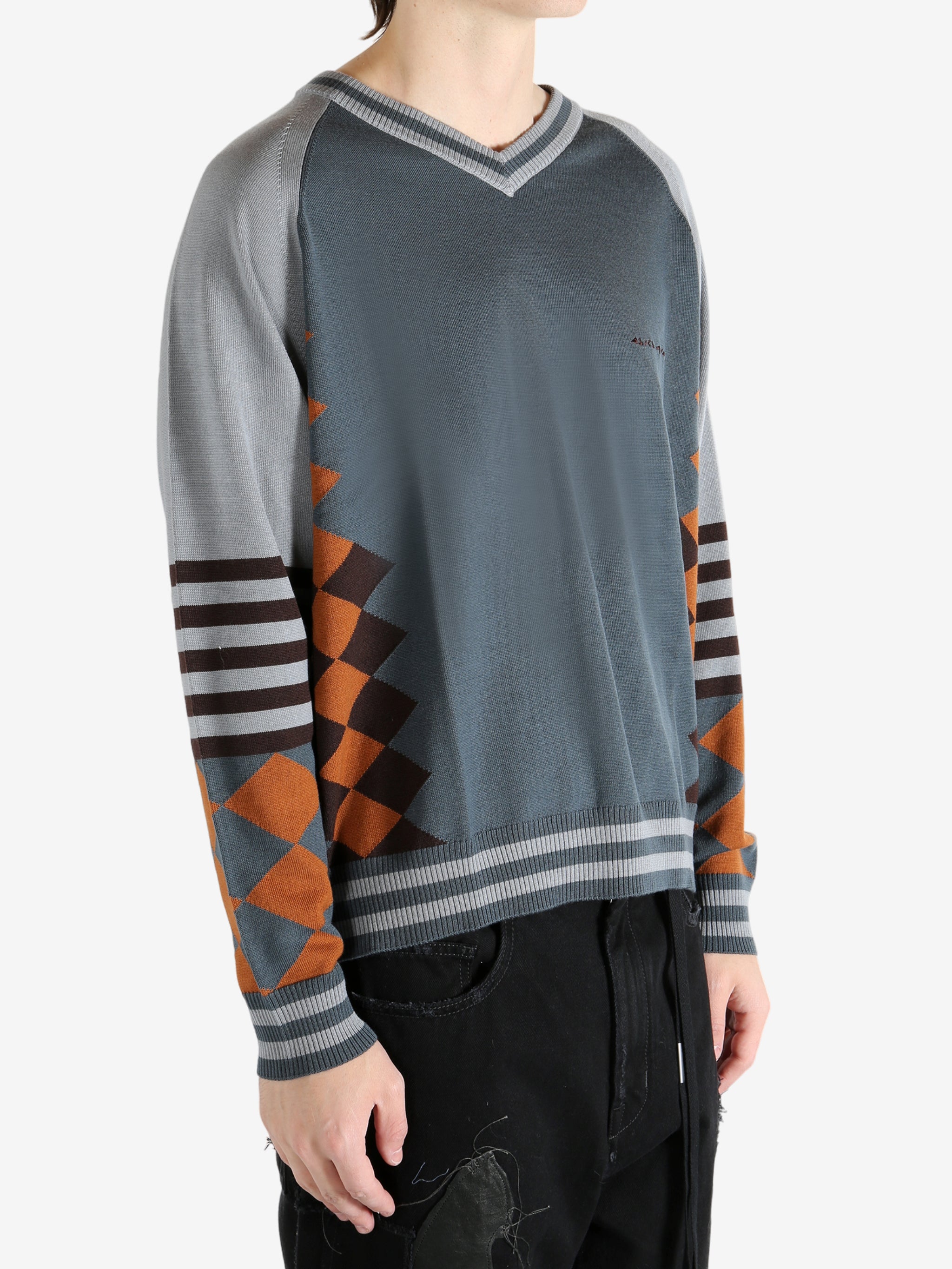 Grey jumper worn by a person, showing the jumper's fit