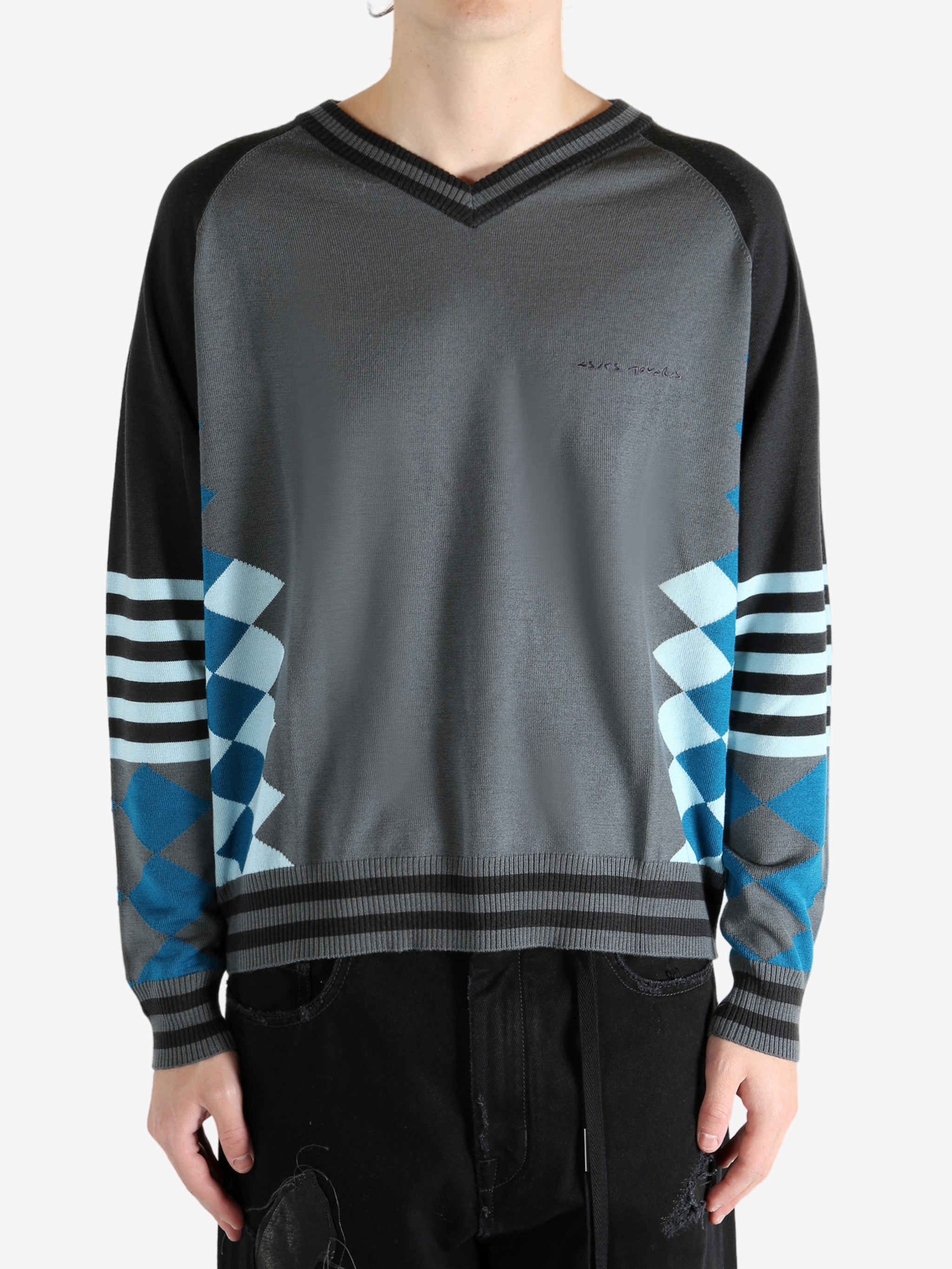 Grey jumper worn by a person, showing the jumper's fit