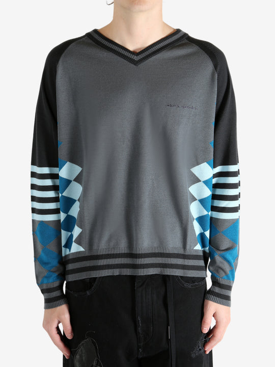 Grey jumper worn by a person, showing the jumper's fit