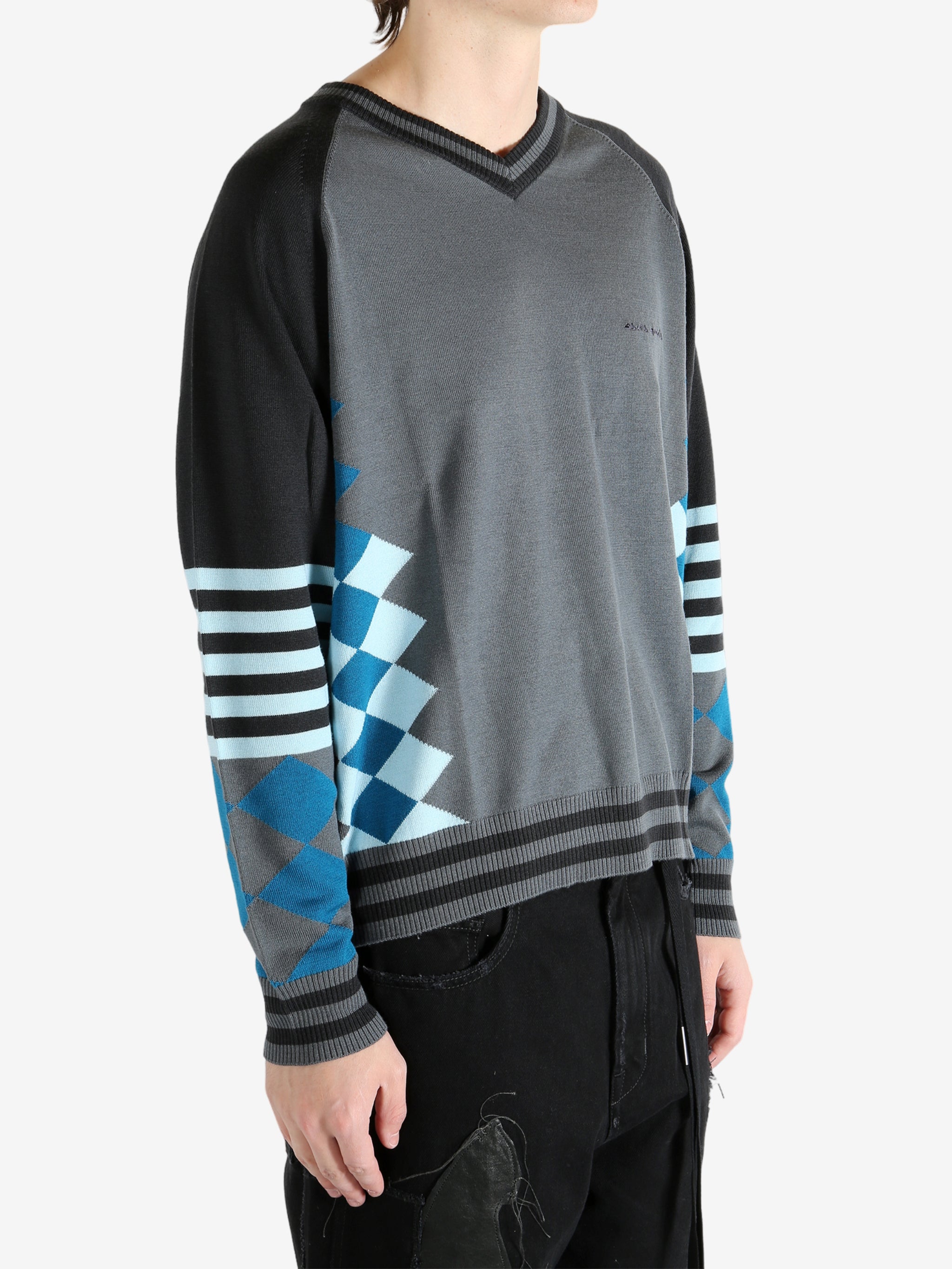 Grey jumper worn by a person, showing the jumper's fit