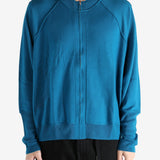 Blue cardigan worn by a person, showing the cardigan's fit