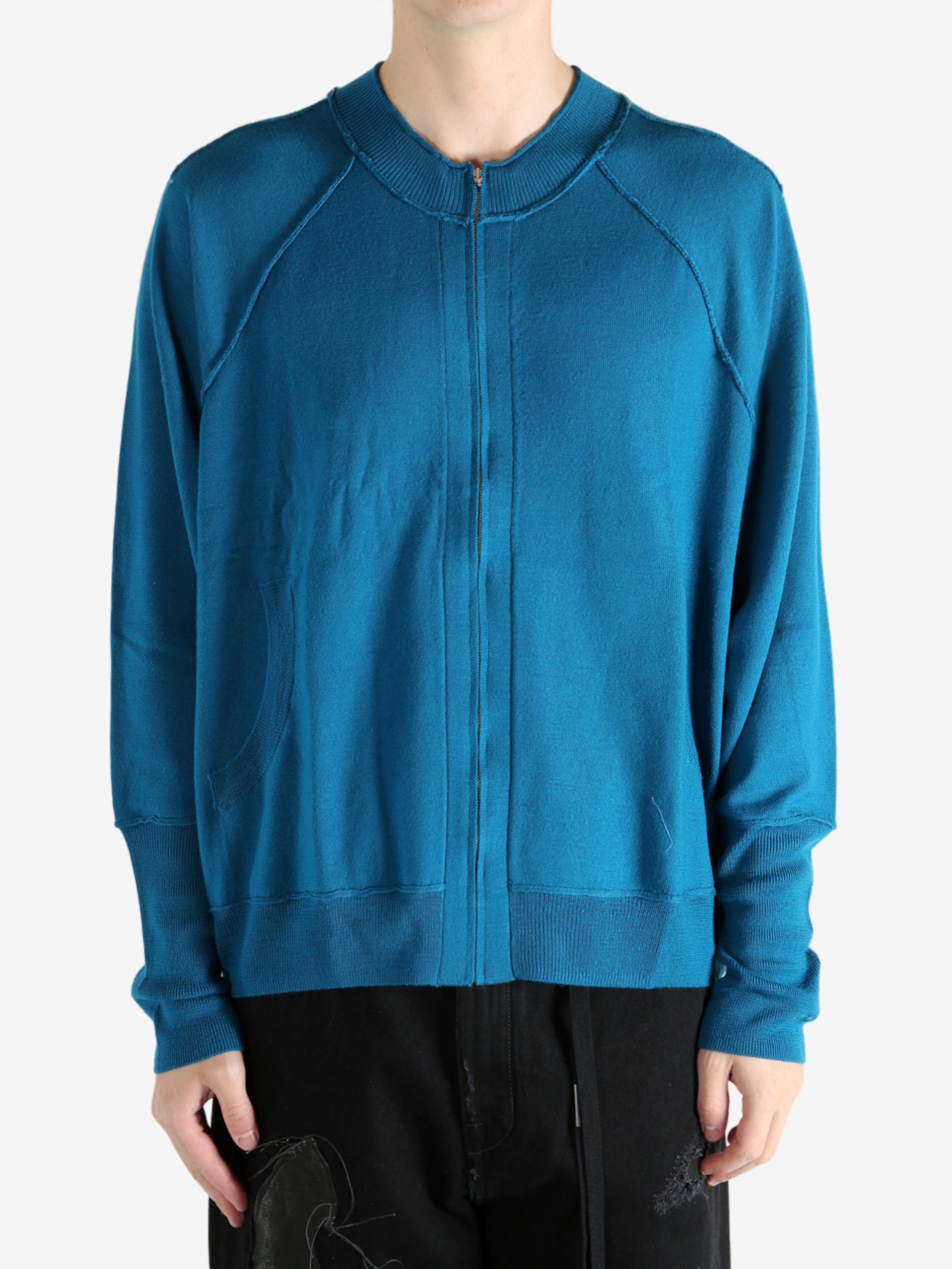 Blue cardigan worn by a person, showing the cardigan's fit