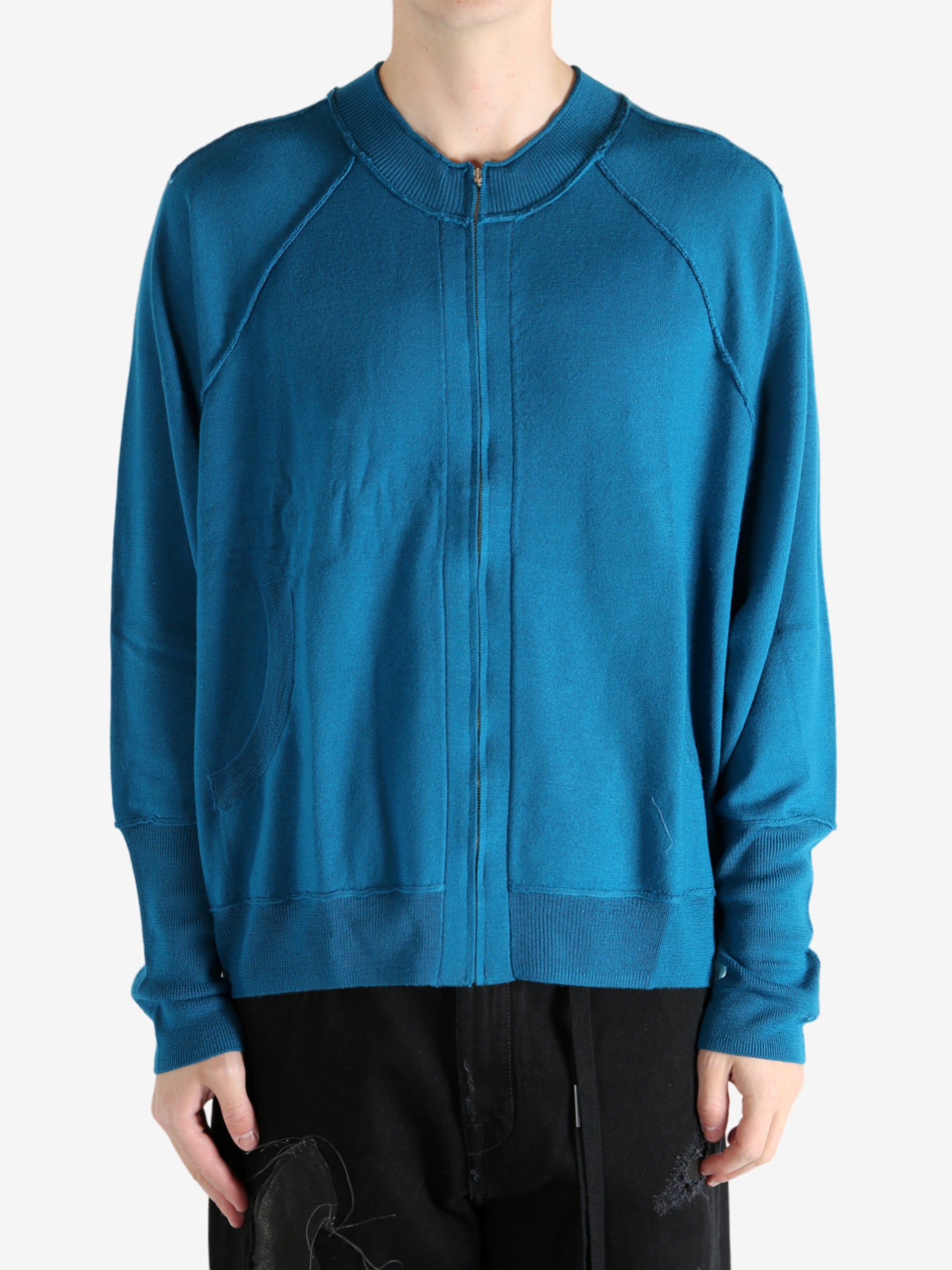 Blue cardigan worn by a person, showing the cardigan's fit