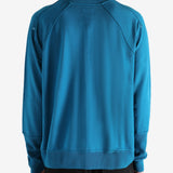 Blue cardigan worn by a person, showing the cardigan's fit