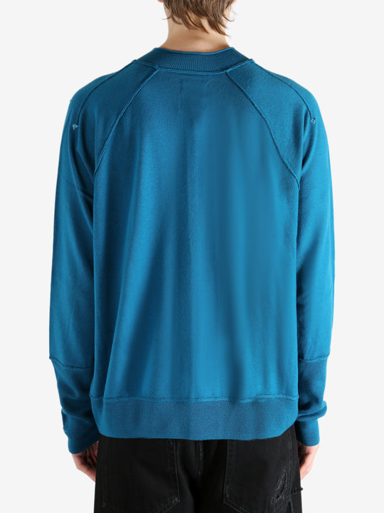 Blue cardigan worn by a person, showing the cardigan's fit