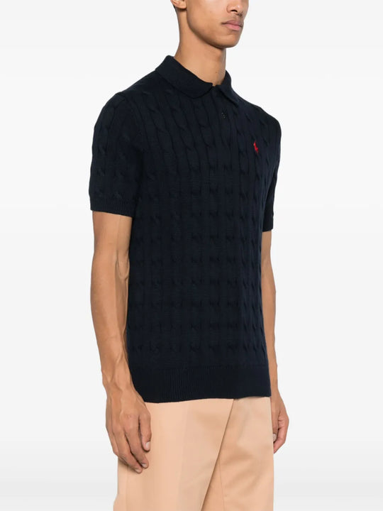 Navy knitwear worn by a person, showing the knitwear fit