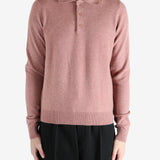 Pink sweater worn by a person, showing the sweater's fit