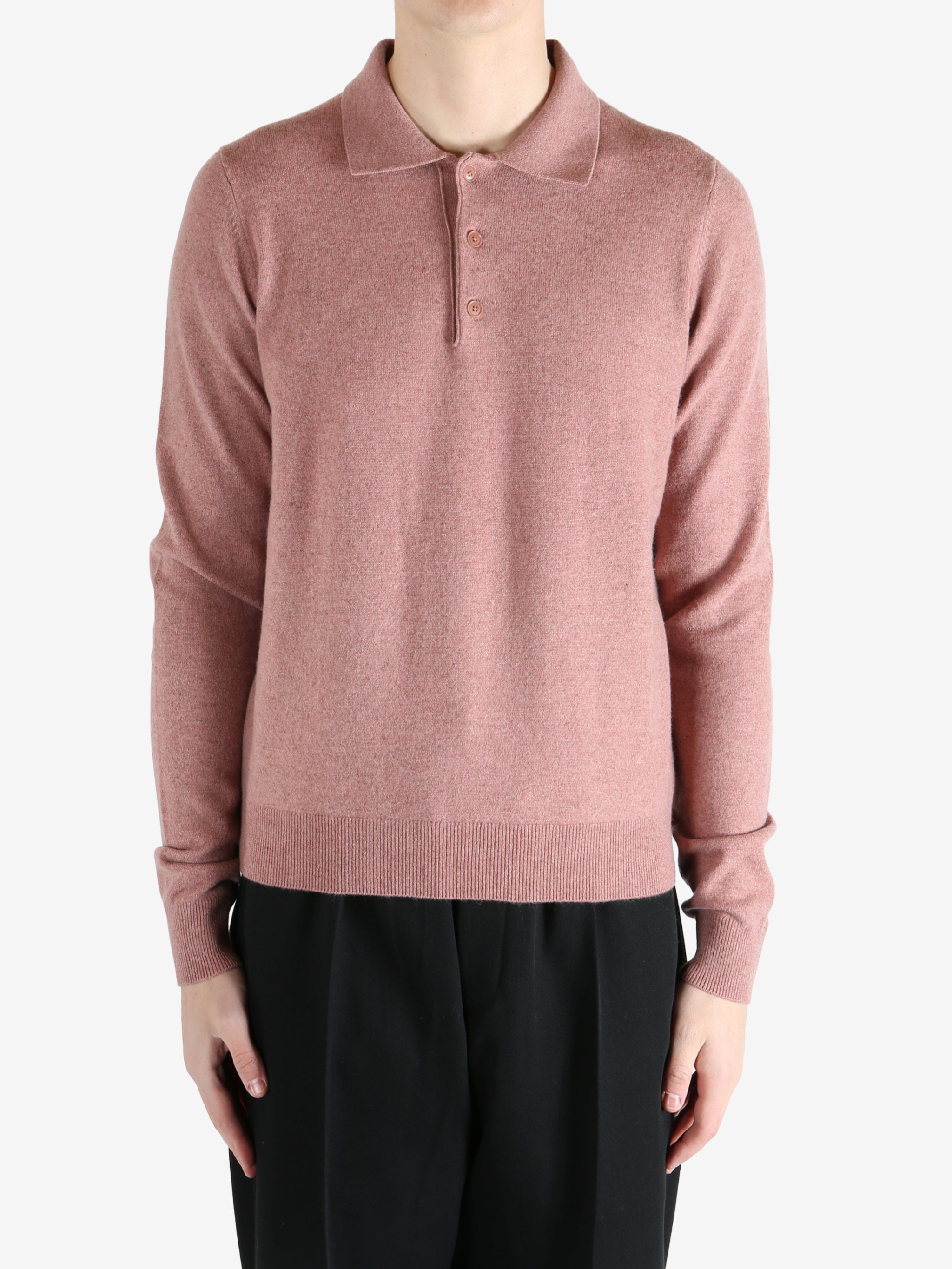 Pink sweater worn by a person, showing the sweater's fit