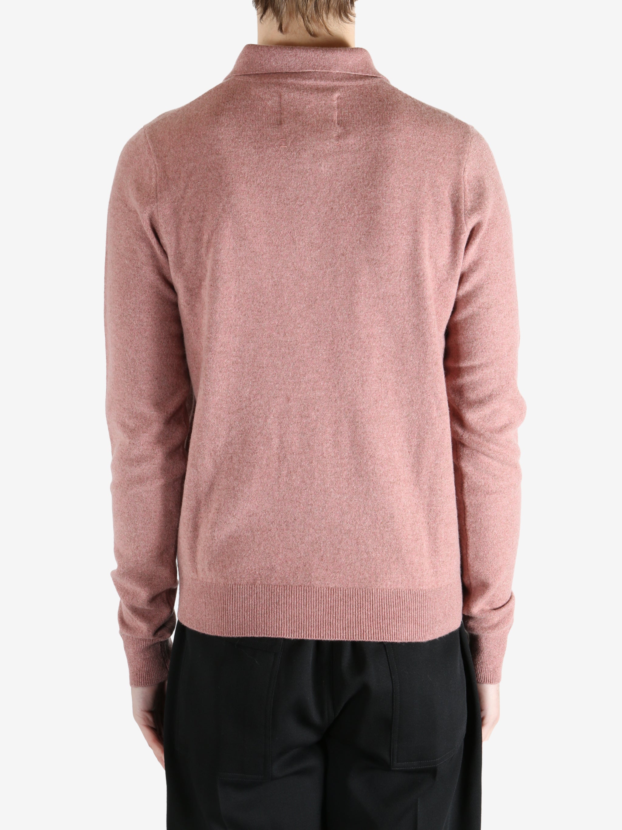 Pink sweater worn by a person, showing the sweater's fit