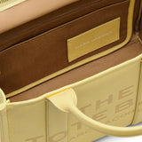 close up of yellow bags, showing texture of the leather fabric