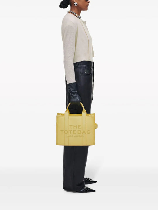 yellow bags worn by a person, showing the bags fit