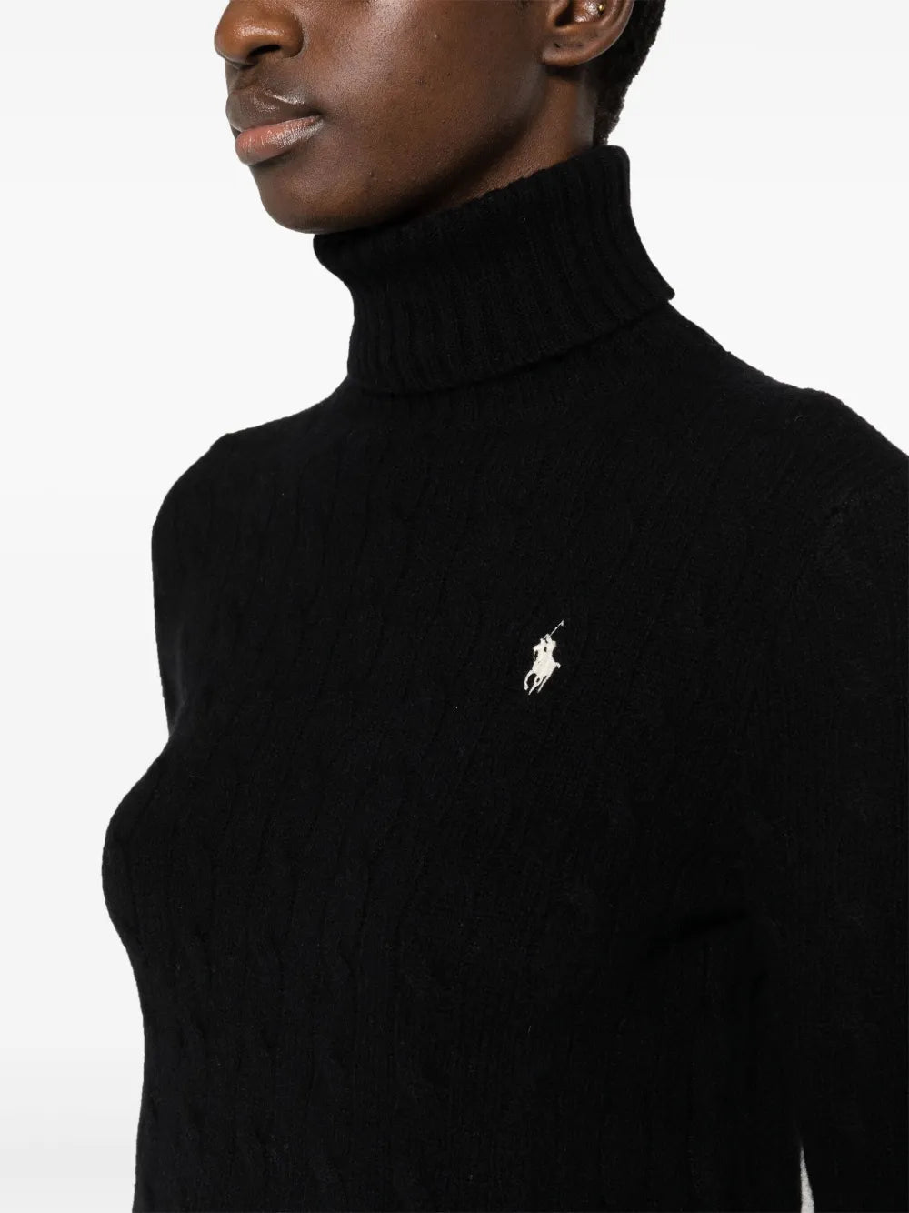 Close up of black knitwear, showing texture of the wool and  Cashmere fabric