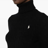 Close up of black knitwear, showing texture of the wool and  Cashmere fabric