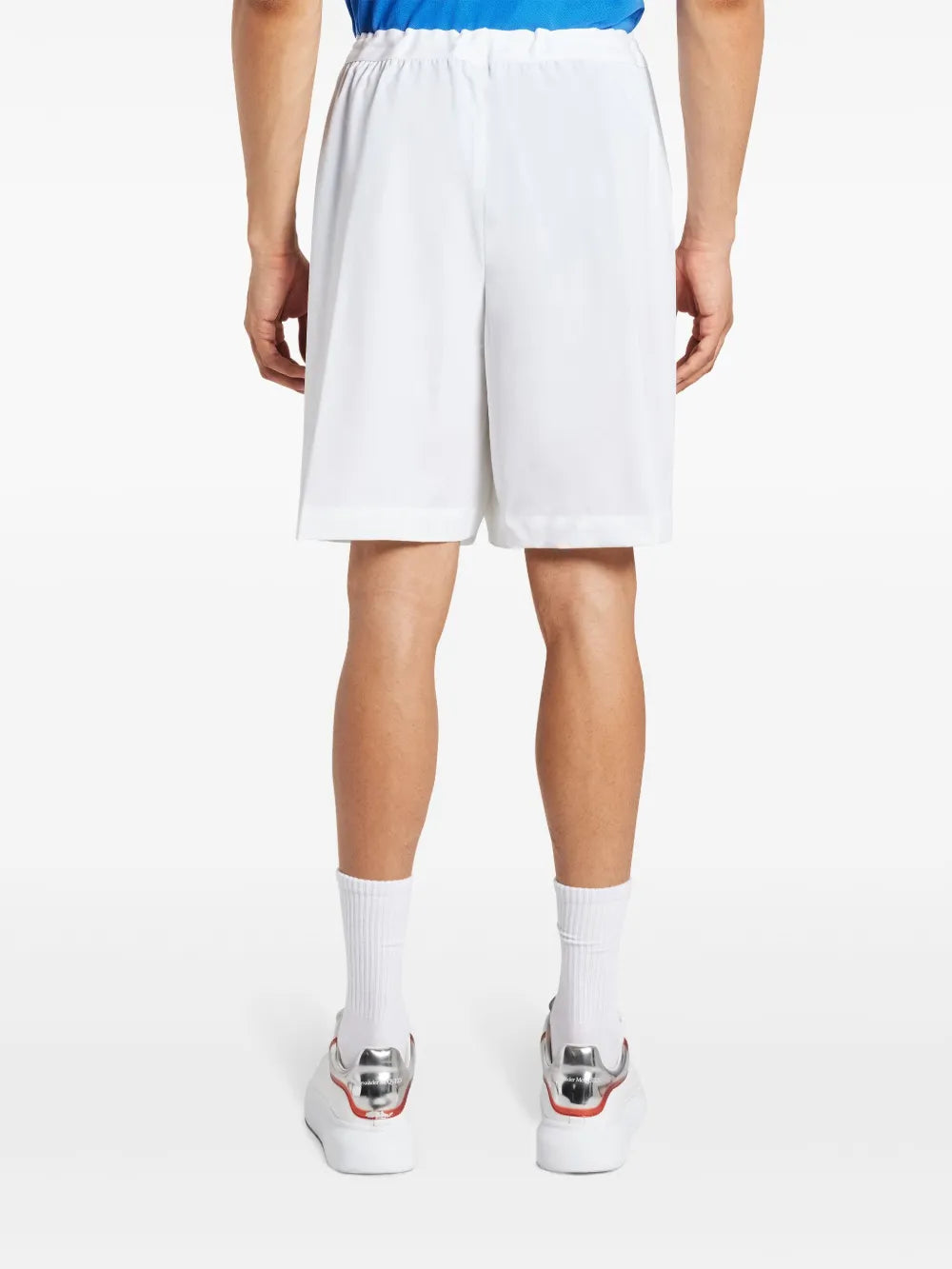 White shorts worn by a person, showing the shorts fit