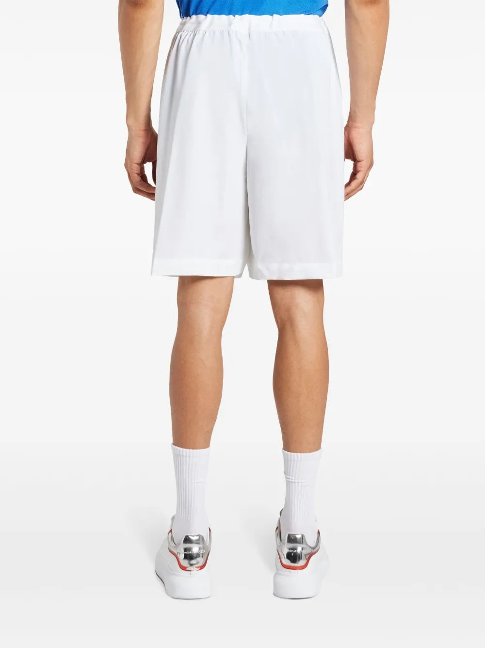 White shorts worn by a person, showing the shorts fit