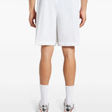 White shorts worn by a person, showing the shorts fit