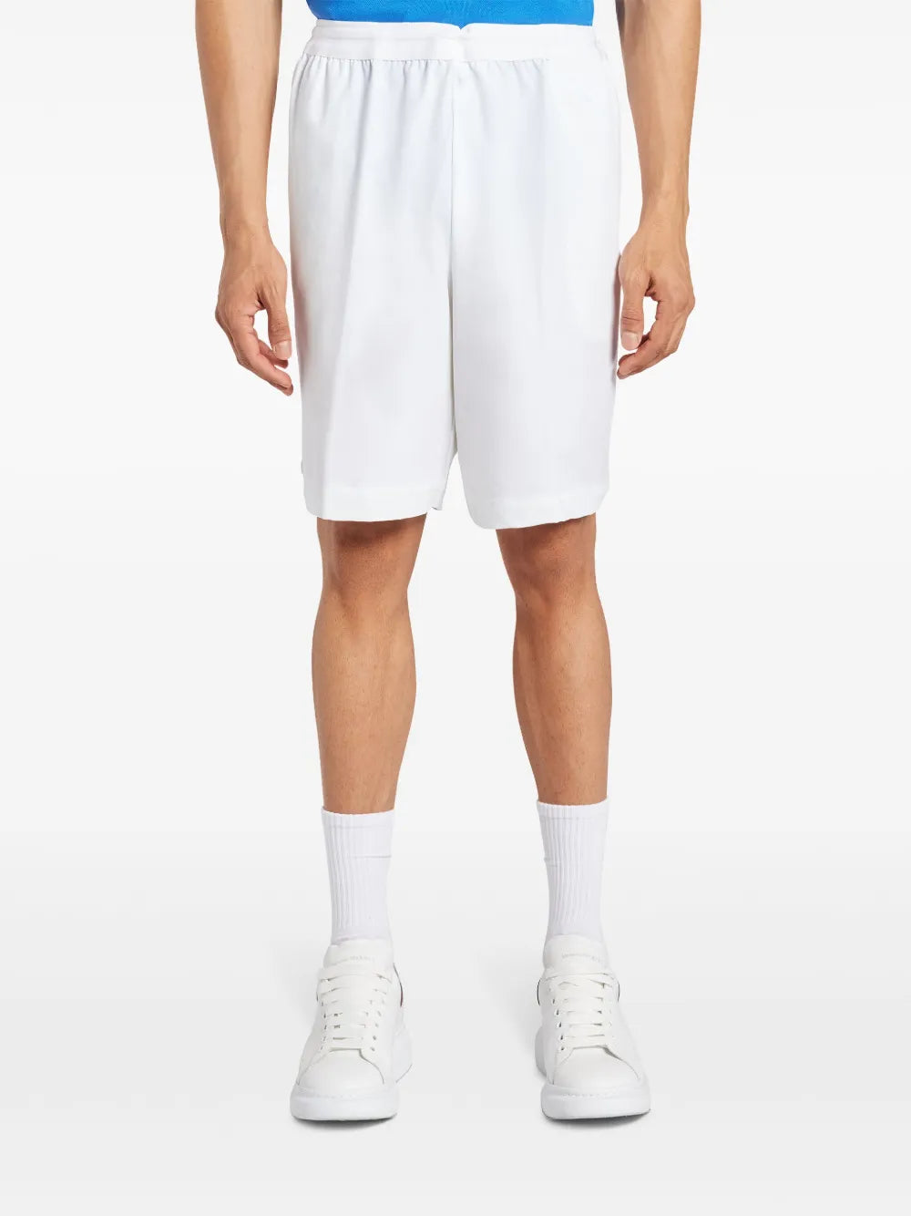 White shorts worn by a person, showing the shorts fit