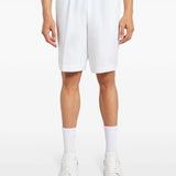 White shorts worn by a person, showing the shorts fit