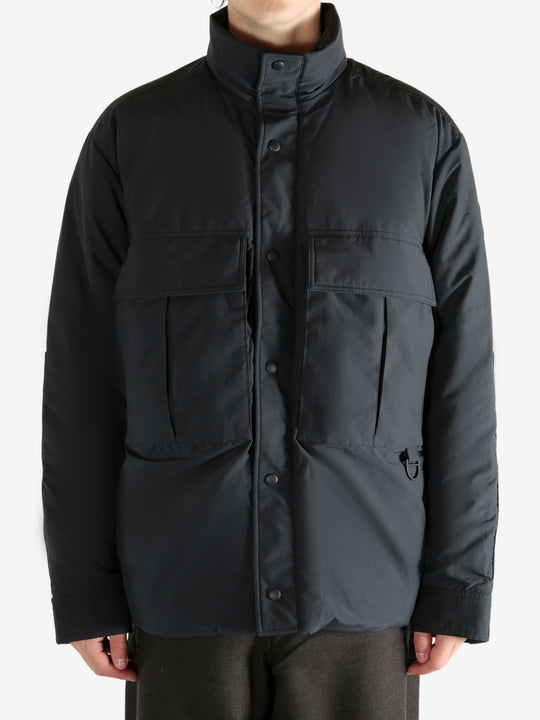 Black jacket worn by a person, showing the jacket's fit