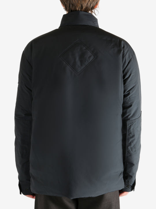 Black jacket worn by a person, showing the jacket's fit