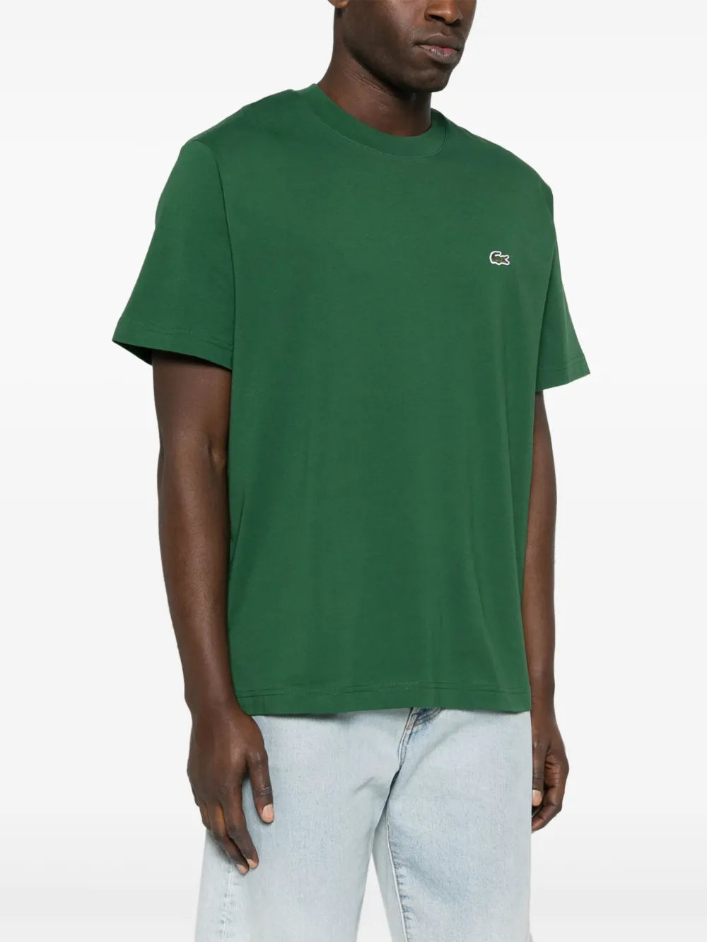 Green t-shirt worn by a person, showing the t-shirt's fit