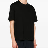 Black t-shirt worn by a person, showing the t-shirt fit
