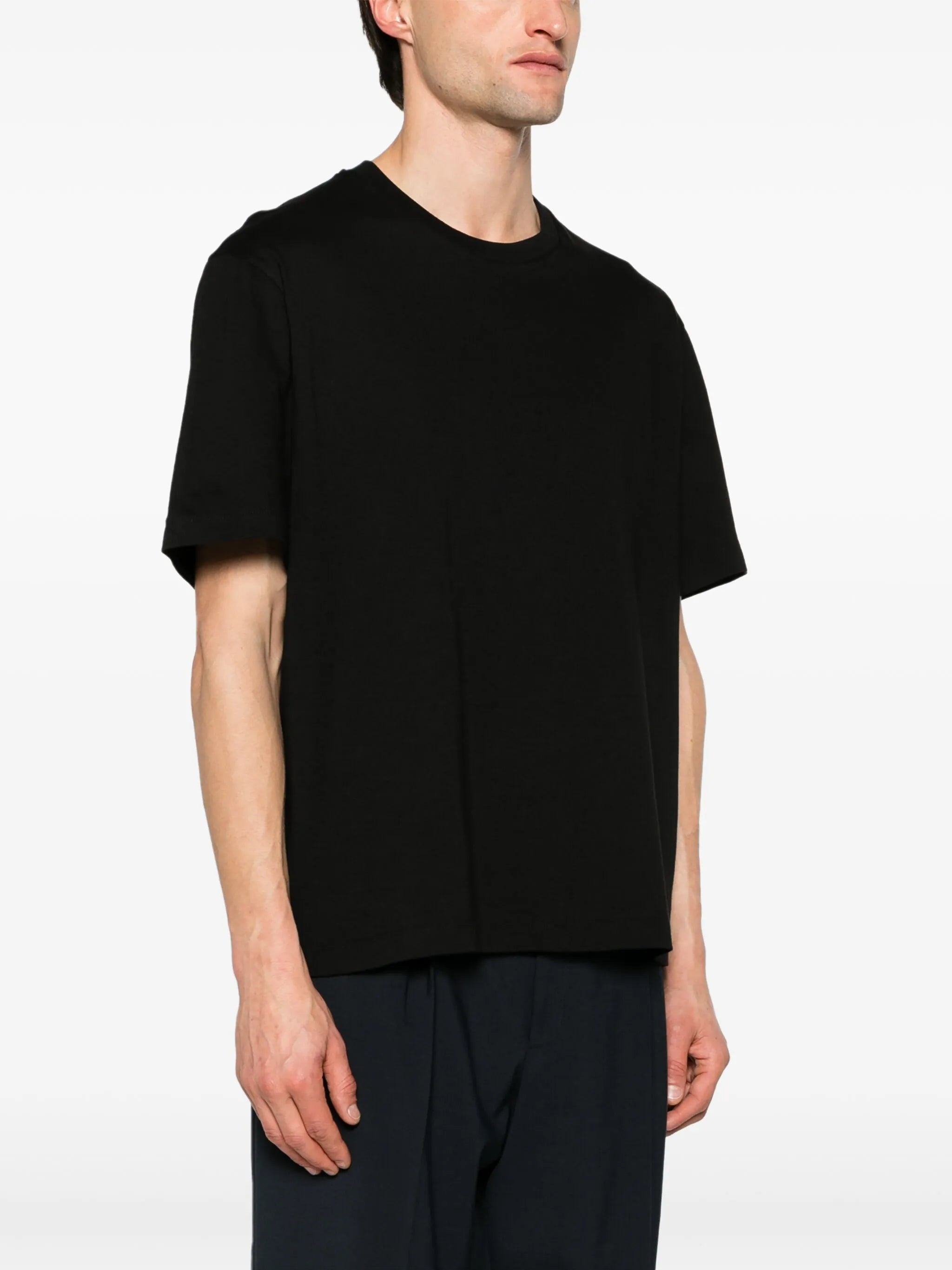 Black t-shirt worn by a person, showing the t-shirt fit