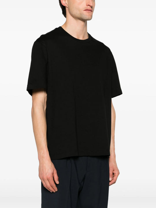 Black t-shirt worn by a person, showing the t-shirt fit