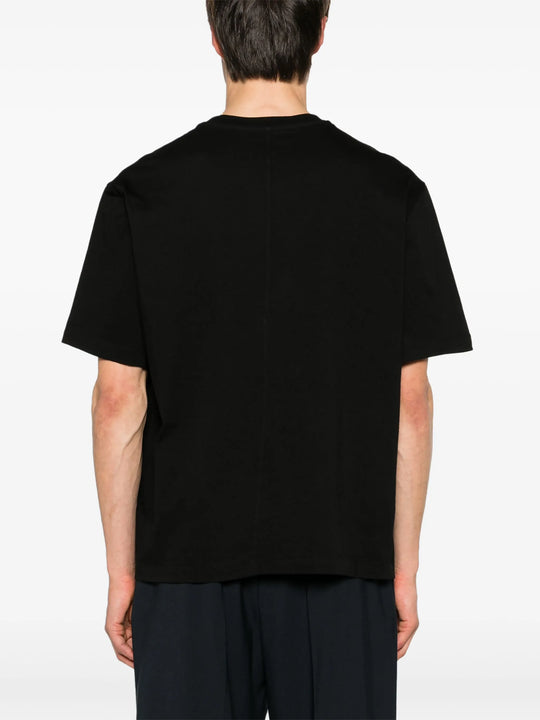 Black t-shirt worn by a person, showing the t-shirt fit