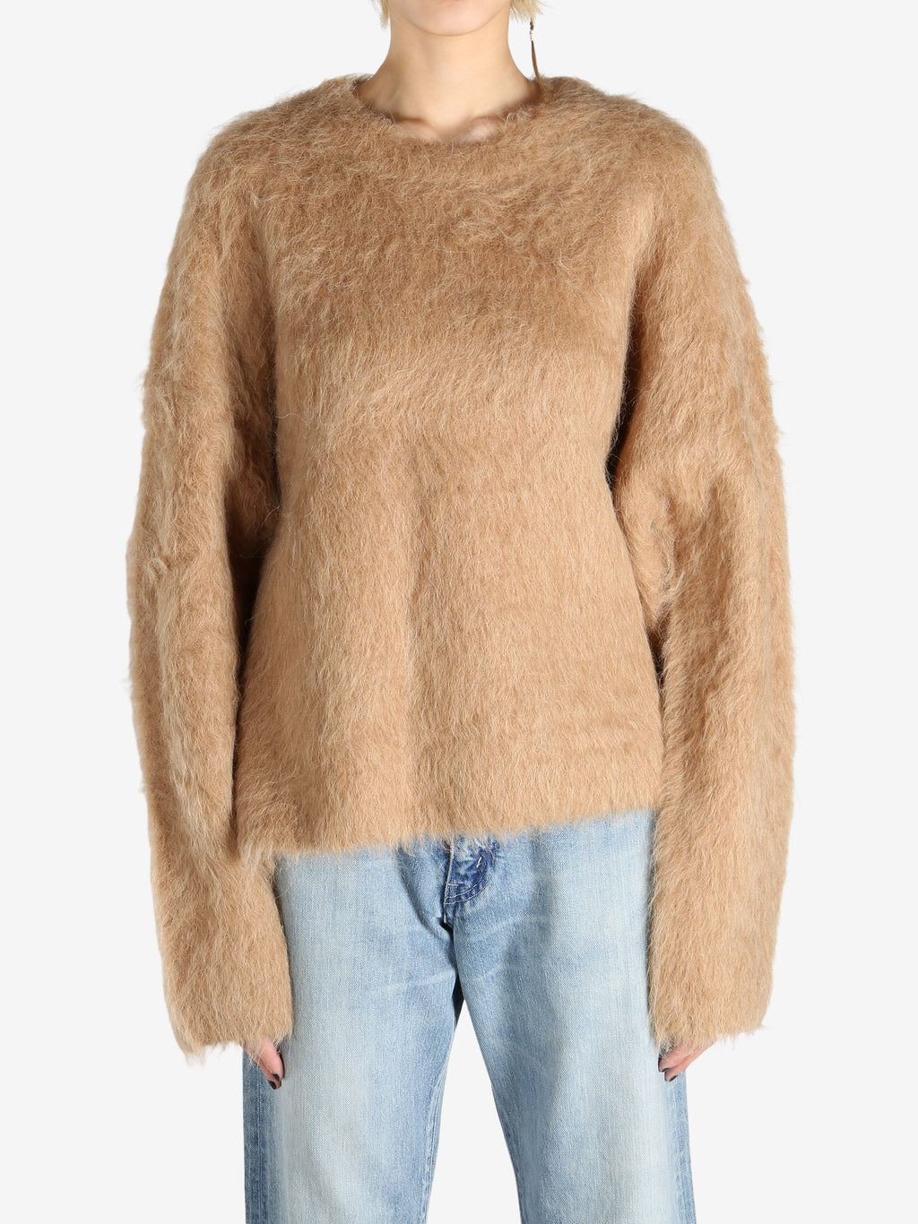 Brown knitwear worn by a person, showing the knitwear fit